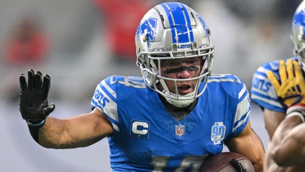 Lions receiver Amon-Ra St. Brown runs down the field with the ball.